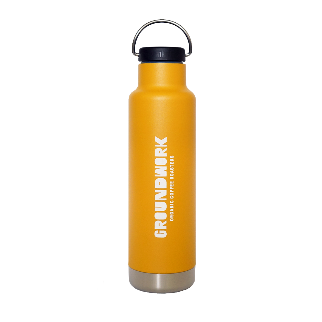 The Klean Kanteen 20oz insulated water bottle by Groundwork Coffee is tall, yellow, with a black lid, silver base, white vertical logo, and leakproof Climate Lock™.
