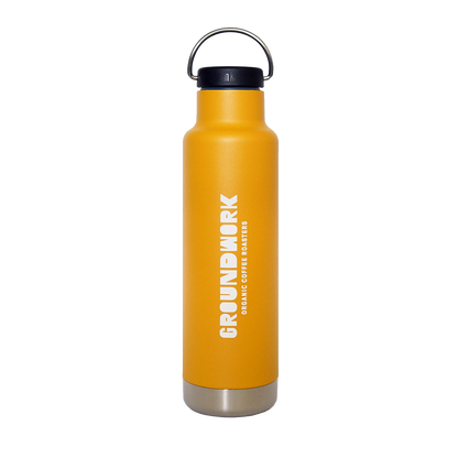 The Klean Kanteen 20oz insulated water bottle by Groundwork Coffee is tall, yellow, with a black lid, silver base, white vertical logo, and leakproof Climate Lock™.